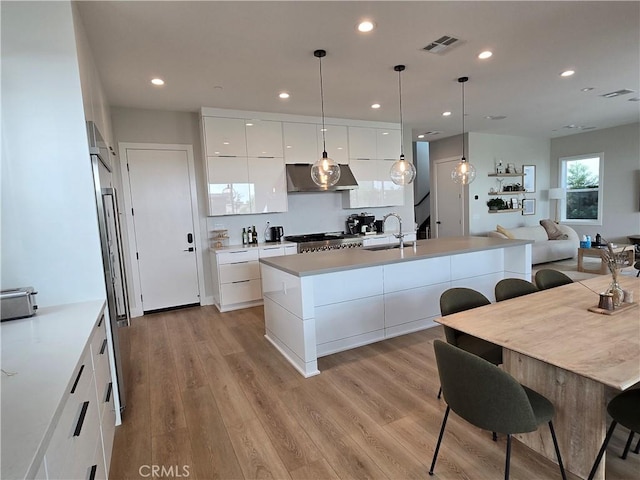 171 Bear Leaf Dr, Lake Forest, CA 92630 - kitchen with modern cabinets, extractor fan, white cabinets, light wood-style flooring, and recessed lighting