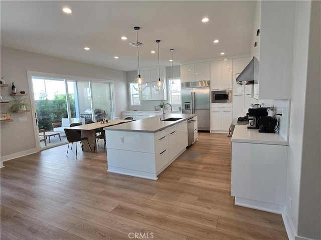 171 Bear Leaf Dr, Lake Forest, CA 92630 - kitchen featuring built in appliances, modern cabinets, wall chimney range hood, recessed lighting, and white cabinetry