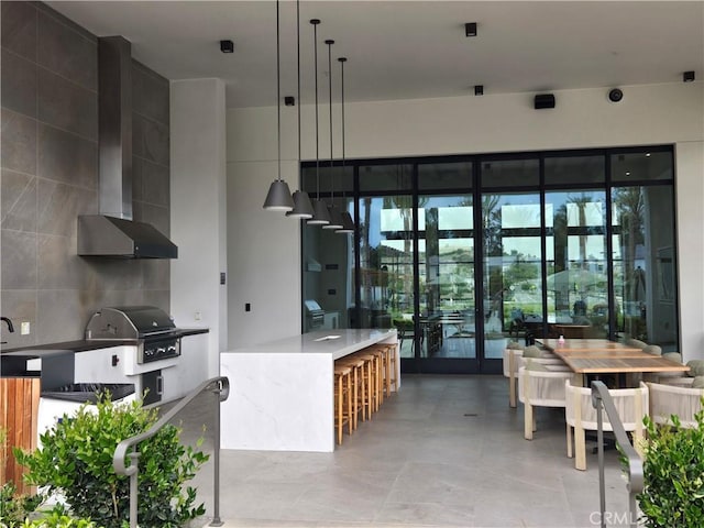 171 Bear Leaf Dr, Lake Forest, CA 92630 - kitchen with wall chimney exhaust hood, pendant lighting, a kitchen island, modern cabinets, and tasteful backsplash