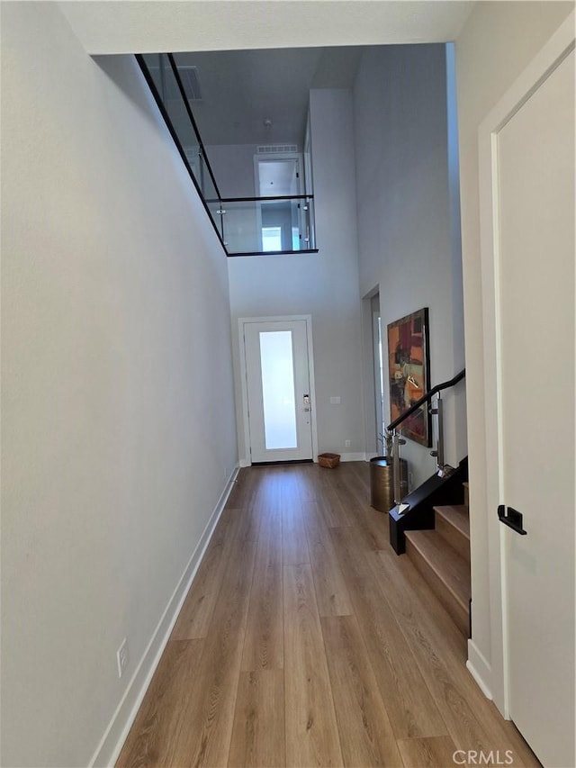171 Bear Leaf Dr, Lake Forest, CA 92630 - hallway with a towering ceiling, wood finished floors, and stairs
