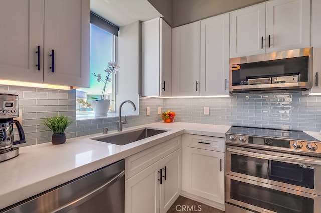 488 E Ocean Blvd Unit 502, Long Beach, CA 90802 - kitchen with appliances with stainless steel finishes, white cabinets, light countertops, and decorative backsplash