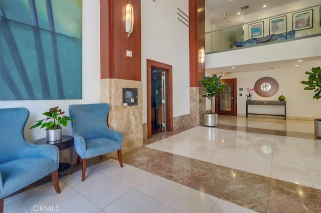 488 E Ocean Blvd Unit 502, Long Beach, CA 90802 - lobby with wainscoting, tile walls, and a towering ceiling