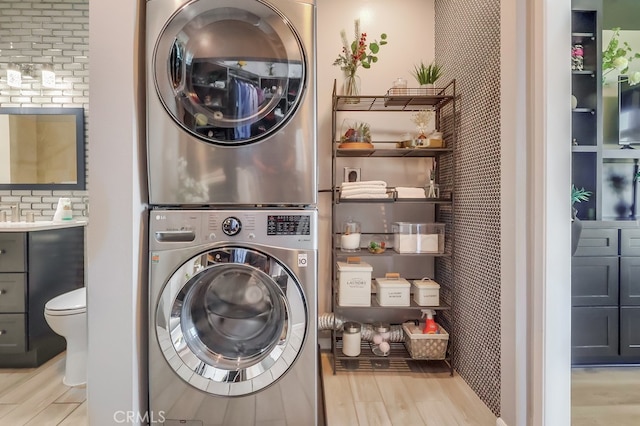 488 E Ocean Blvd Unit 502, Long Beach, CA 90802 - laundry area with stacked washing machine and dryer and wood finished floors