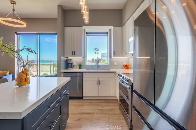 488 E Ocean Blvd Unit 502, Long Beach, CA 90802 - kitchen with appliances with stainless steel finishes, light wood-type flooring, white cabinets, and light countertops