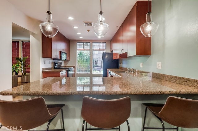 488 E Ocean Blvd Unit 502, Long Beach, CA 90802 - kitchen with stainless steel appliances, a peninsula, light stone countertops, a breakfast bar area, and recessed lighting