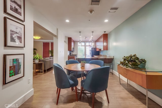 488 E Ocean Blvd Unit 502, Long Beach, CA 90802 - dining area featuring light wood-style floors and recessed lighting
