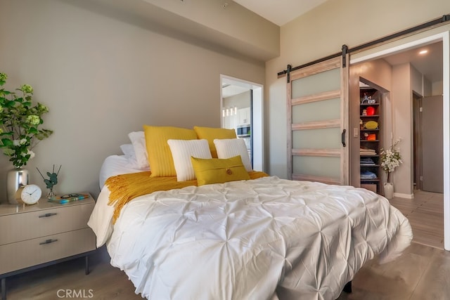 488 E Ocean Blvd Unit 502, Long Beach, CA 90802 - bedroom featuring a barn door and wood finished floors