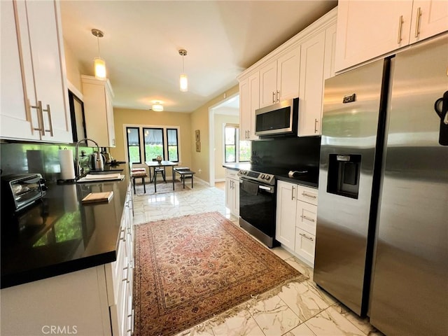 542 N Kilkea Dr, Los Angeles, CA 90048 - kitchen with appliances with stainless steel finishes, dark countertops, light marble finish flooring, and white cabinetry