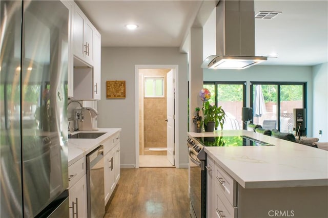 542 N Kilkea Dr, Los Angeles, CA 90048 - kitchen featuring stainless steel appliances, island range hood, a kitchen island, plenty of natural light, and recessed lighting
