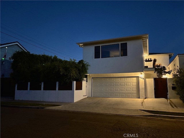 542 N Kilkea Dr, Los Angeles, CA 90048 - view of front facade featuring stucco siding, a garage, and concrete driveway