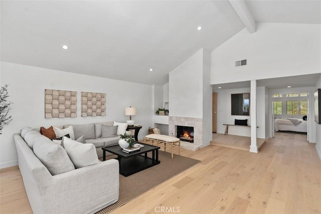 317 Calle Familia, San Clemente, CA 92672 - living room featuring beamed ceiling, light wood-style floors, high vaulted ceiling, a lit fireplace, and recessed lighting