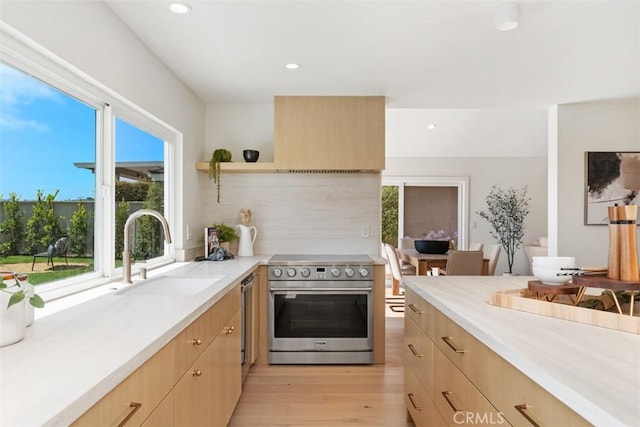 317 Calle Familia, San Clemente, CA 92672 - kitchen with electric range, light brown cabinets, light countertops, light wood-type flooring, and recessed lighting