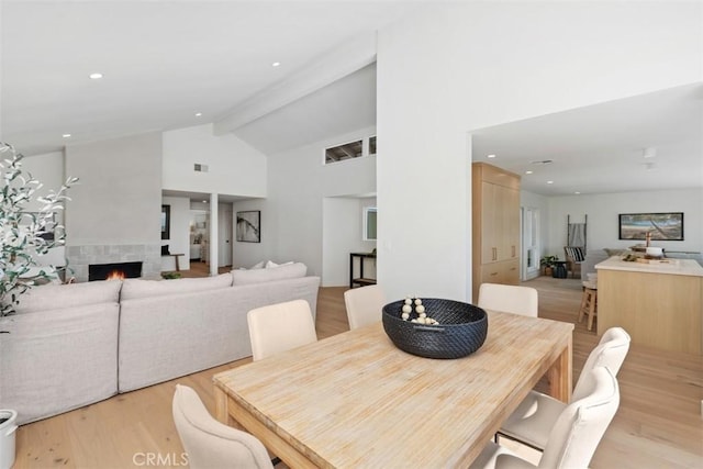 317 Calle Familia, San Clemente, CA 92672 - dining space featuring light wood-style floors, a tile fireplace, high vaulted ceiling, beam ceiling, and recessed lighting
