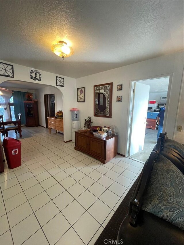 4153 N Webster Ave, Perris, CA 92571 - living room with arched walkways, a textured ceiling, and light tile patterned floors