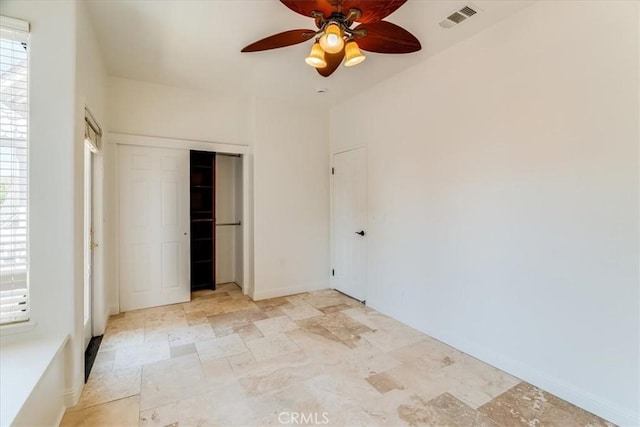 558 Adina Way, Nipomo, CA 93444 - unfurnished bedroom with multiple windows, light stone finish floors, a closet, and a ceiling fan