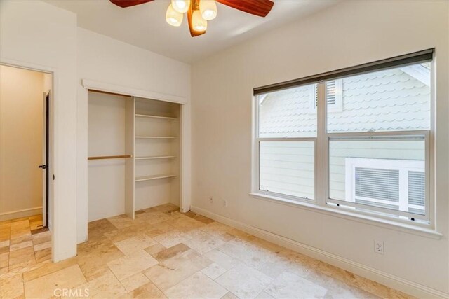 558 Adina Way, Nipomo, CA 93444 - unfurnished bedroom featuring multiple windows, a closet, light stone finish flooring, and ceiling fan