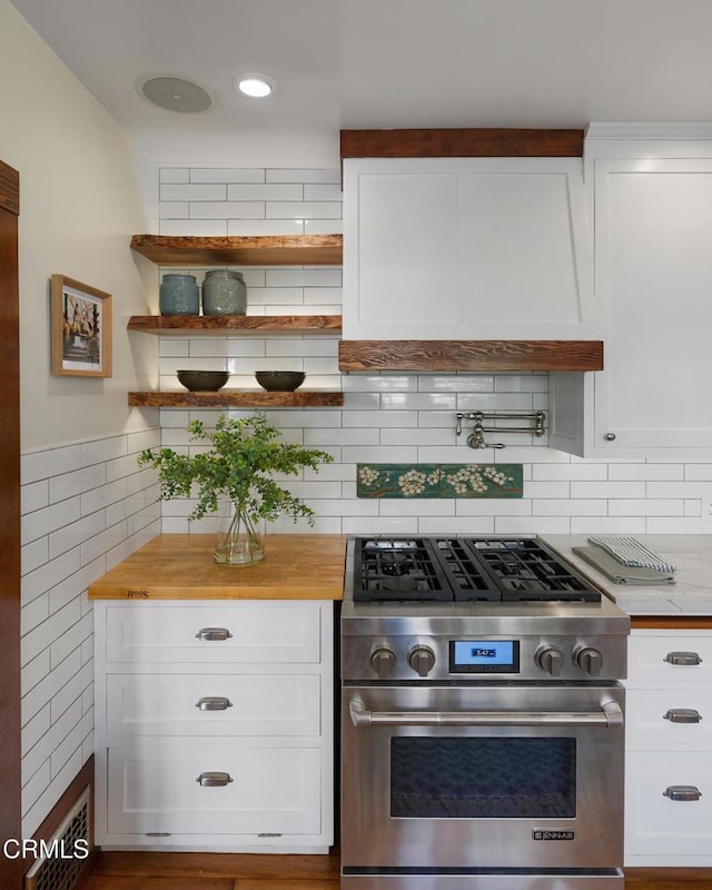 1036 N Chester Ave, Pasadena, CA 91104 - kitchen with high end stainless steel range, butcher block countertops, white cabinets, open shelves, and decorative backsplash