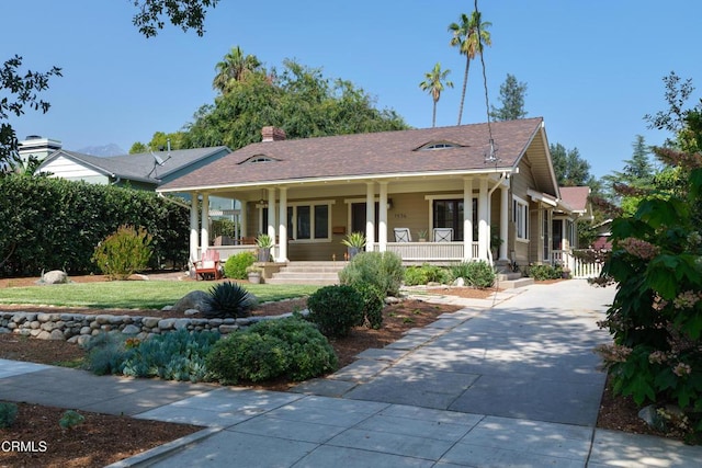 1036 N Chester Ave, Pasadena, CA 91104 - view of front of home featuring covered porch, driveway, and a chimney