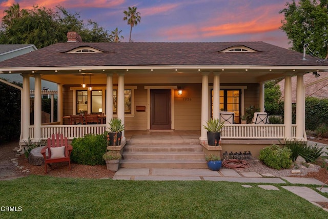 1036 N Chester Ave, Pasadena, CA 91104 - view of front facade with covered porch, a shingled roof, a lawn, and a chimney
