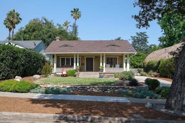 1036 N Chester Ave, Pasadena, CA 91104 - view of front of house with a porch, a front lawn, and a chimney