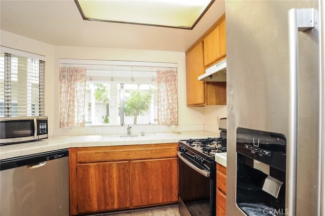 3342 Darby St Unit 317, Simi Valley, CA 93063 - kitchen featuring appliances with stainless steel finishes, under cabinet range hood, and brown cabinetry