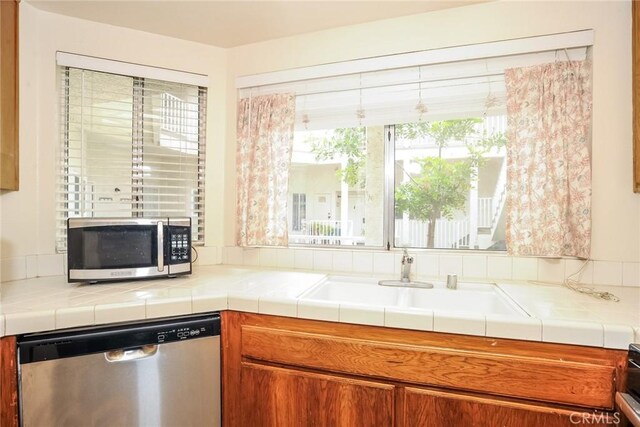3342 Darby St Unit 317, Simi Valley, CA 93063 - kitchen with stainless steel appliances, brown cabinets, and tile countertops