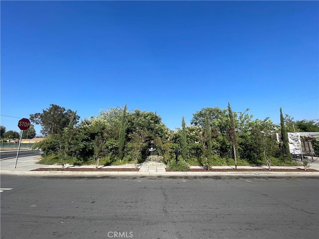13260 Moreno Way, Moreno Valley, CA 92553 - view of asphalt road featuring traffic signs, sidewalks, and curbs