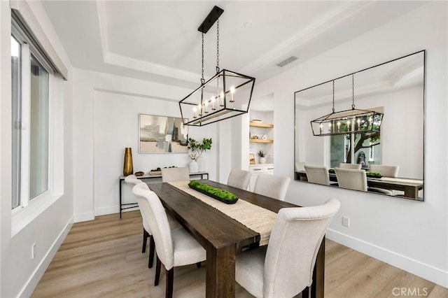 308 Via El Patio, San Clemente, CA 92673 - dining room featuring a chandelier, a tray ceiling, and light wood-style flooring