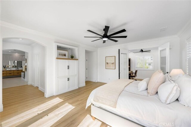 308 Via El Patio, San Clemente, CA 92673 - bedroom featuring crown molding, arched walkways, light wood-style flooring, a ceiling fan, and connected bathroom
