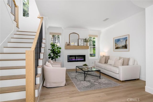 308 Via El Patio, San Clemente, CA 92673 - living room featuring ornamental molding, stairs, wood finished floors, and a glass covered fireplace