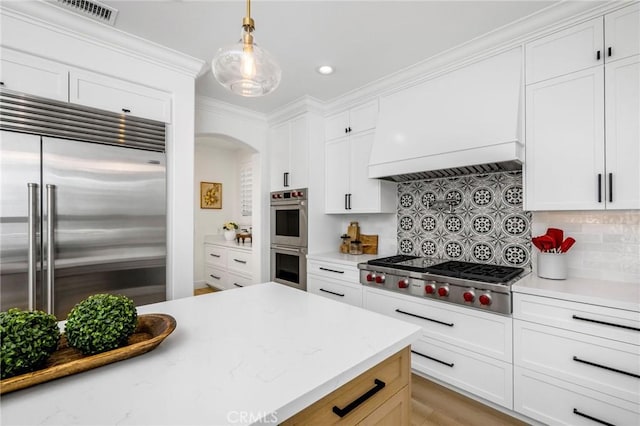 308 Via El Patio, San Clemente, CA 92673 - kitchen with appliances with stainless steel finishes, arched walkways, backsplash, white cabinets, and crown molding