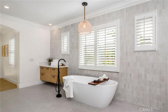 308 Via El Patio, San Clemente, CA 92673 - full bath featuring tile walls, crown molding, a soaking tub, healthy amount of natural light, and vanity