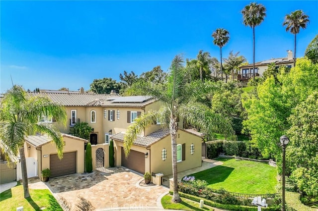308 Via El Patio, San Clemente, CA 92673 - mediterranean / spanish-style house with roof mounted solar panels, stucco siding, a garage, driveway, and a tile roof