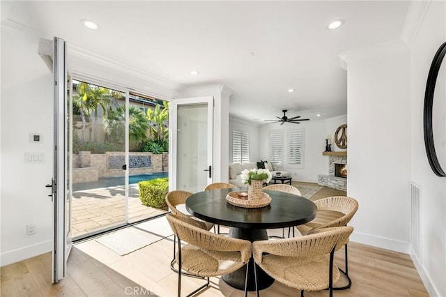 308 Via El Patio, San Clemente, CA 92673 - dining room featuring a ceiling fan, recessed lighting, light wood finished floors, a stone fireplace, and crown molding