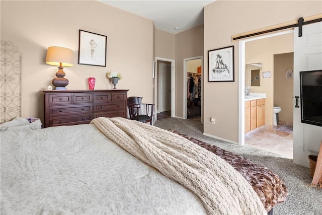 235 Cornuta Way, Nipomo, CA 93444 - carpeted bedroom with a walk in closet, a barn door, a closet, and ensuite bathroom