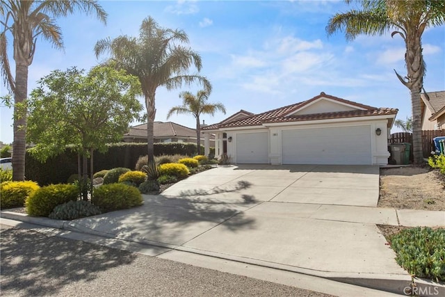 235 Cornuta Way, Nipomo, CA 93444 - view of front of house featuring an attached garage, concrete driveway, stucco siding, and a tile roof