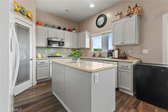 235 Cornuta Way, Nipomo, CA 93444 - kitchen with stainless steel microwave, dishwasher, dark wood finished floors, refrigerator, and light countertops