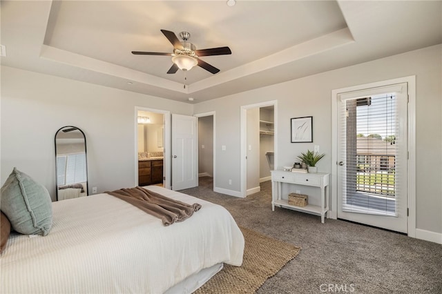2740 Levi Ln, Chico, CA 95973 - carpeted bedroom featuring a tray ceiling, access to outside, a walk in closet, ceiling fan, and ensuite bath