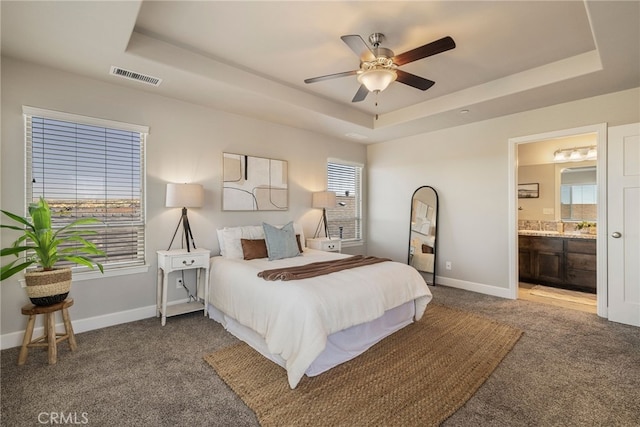 2740 Levi Ln, Chico, CA 95973 - bedroom with a tray ceiling, carpet, multiple windows, and connected bathroom