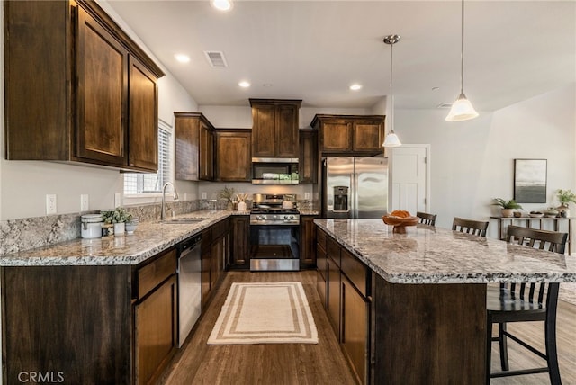 2740 Levi Ln, Chico, CA 95973 - kitchen featuring stainless steel appliances, dark brown cabinetry, dark wood-style floors, and recessed lighting