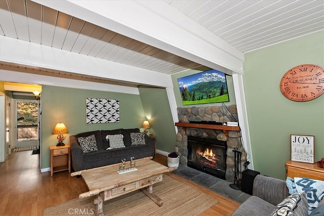 1351 Silverado Rd, Big Bear City, CA 92314 - living area featuring wood finished floors, a stone fireplace, and beamed ceiling