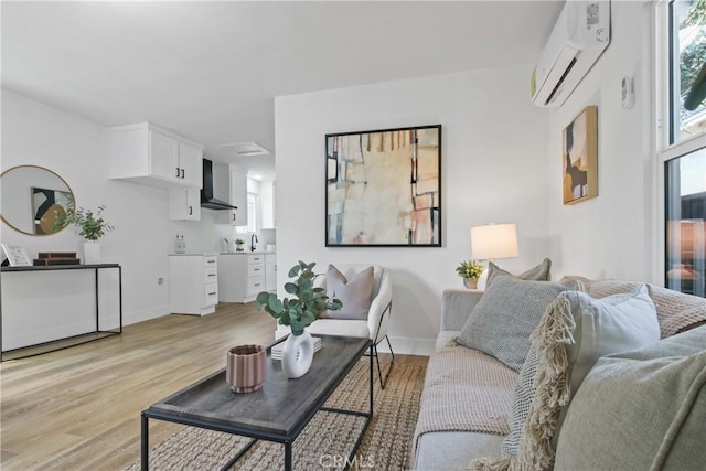 9525 Holmes Ave, Los Angeles, CA 90002 - living area with a wall unit AC and light wood finished floors