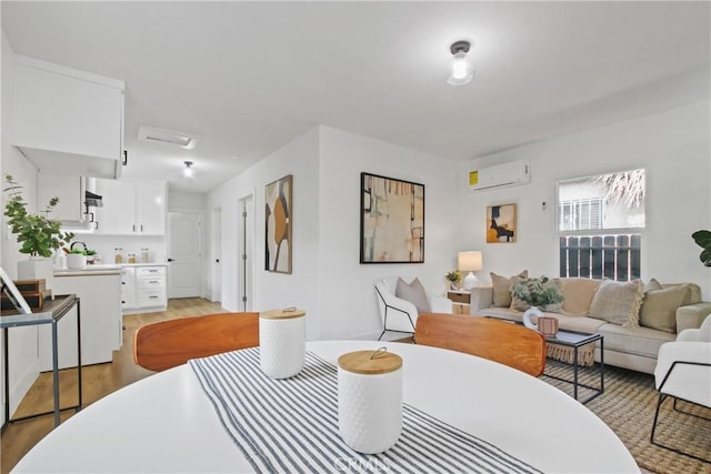 9525 Holmes Ave, Los Angeles, CA 90002 - dining space featuring a wall mounted air conditioner and light wood-style flooring