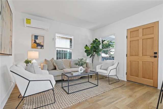 9525 Holmes Ave, Los Angeles, CA 90002 - living area featuring an AC wall unit, healthy amount of natural light, and wood finished floors