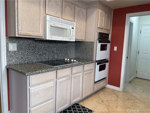 21841 Zuni Dr, Lake Forest, CA 92630 - kitchen with white appliances, decorative backsplash, dark stone countertops, and light tile patterned floors