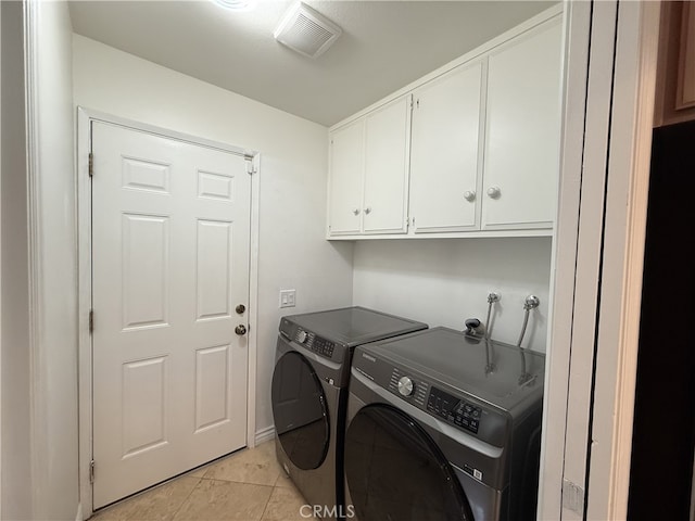 21841 Zuni Dr, Lake Forest, CA 92630 - laundry area with cabinet space, washer and clothes dryer, and light tile patterned floors