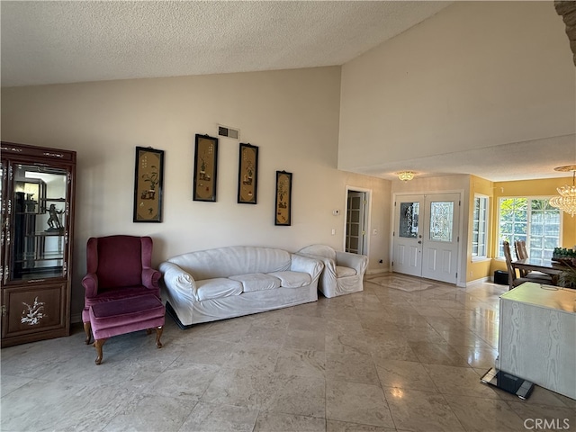 21841 Zuni Dr, Lake Forest, CA 92630 - living room featuring a chandelier, high vaulted ceiling, and a textured ceiling