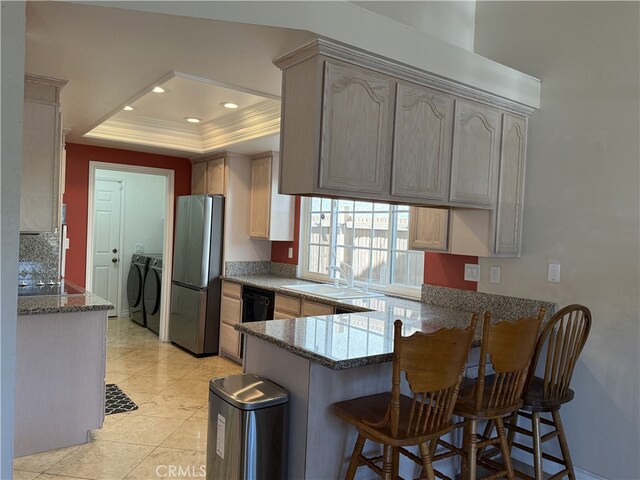 21841 Zuni Dr, Lake Forest, CA 92630 - kitchen with independent washer and dryer, freestanding refrigerator, a peninsula, a raised ceiling, and a kitchen breakfast bar