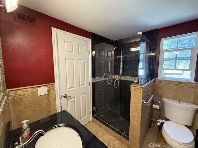 21841 Zuni Dr, Lake Forest, CA 92630 - bathroom featuring tile walls, a stall shower, and a wainscoted wall