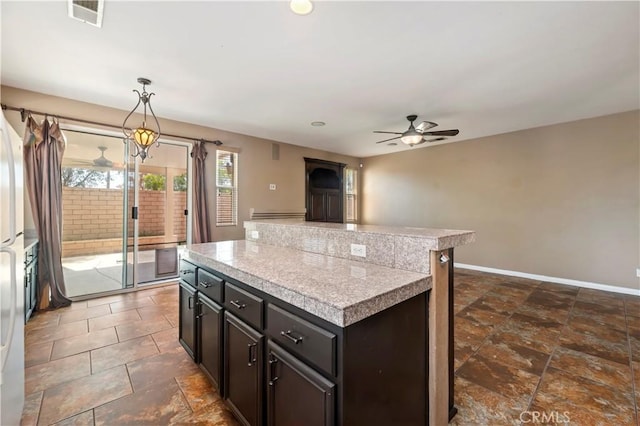 31139 Little Camille Way, Menifee, CA 92584 - kitchen featuring a ceiling fan, tile countertops, a center island, and pendant lighting